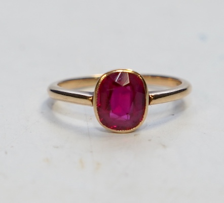 A yellow metal and single stone oval cut synthetic ruby set ring, size L, gross weight 2 grams. Condition - good